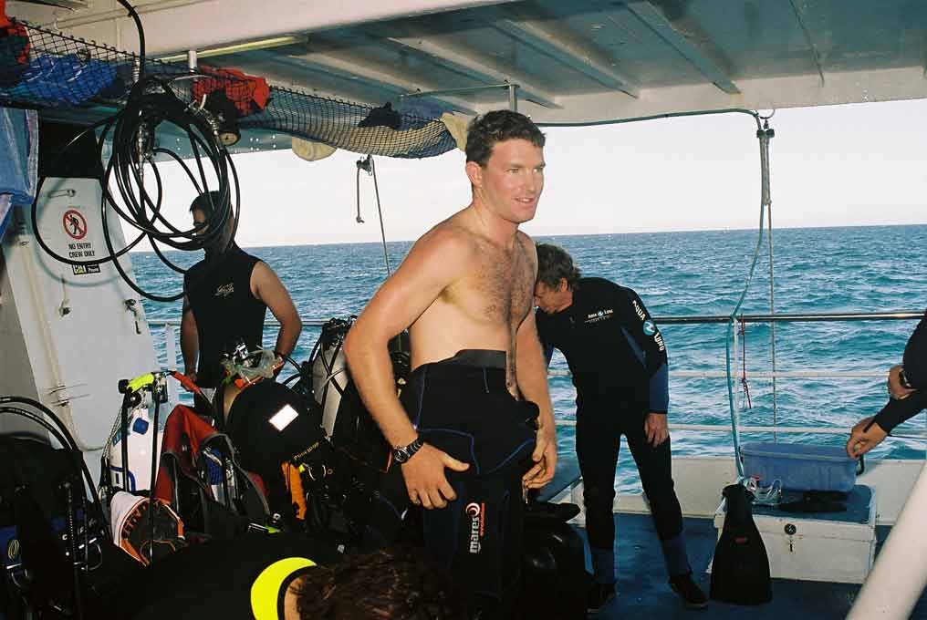 Divers gear up on the dive deck of Big Cat Reality.