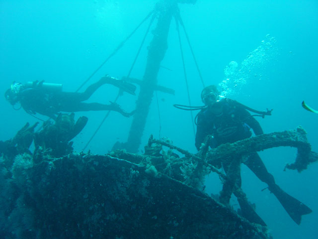 Divers explore the bow of the old coastal trader 'Ann' near Linggatu in the Sunlight Channel, Russell Islands.
