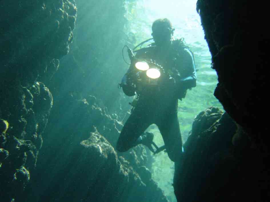 Neil Harris entering a cave in the Solomon Islands. Image by Jenny Harris